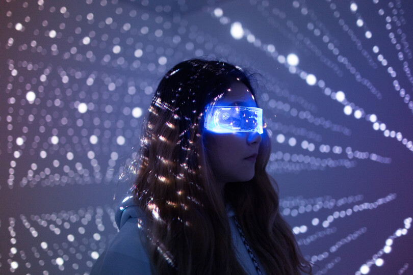Woman-wearing-augmented-reality-glasses-at-night_GettyimagesQiYang