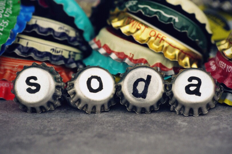 Bottle-Caps-Spelling-Out-the-Word-Soda_GettyimagesAdrienne-Bresnahan
