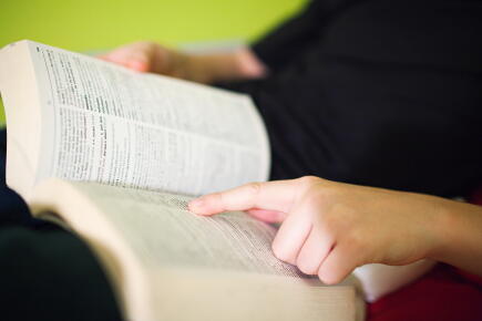 Person-reading-dictionary_Gettyimages-Image-Source