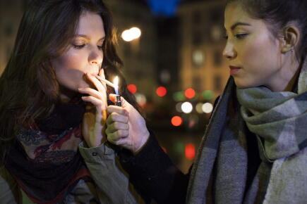 Woman-lighting-friends-cigarette_GettyimagesPhotoAltoSigrid-Olsson