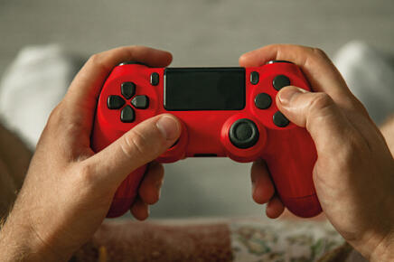 Handsome-man-holding-a-gamepad_GettyimagesIuliia-Bonda