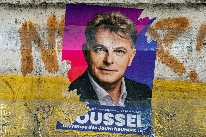 This picture taken on March 18, 2022 in Paris shows a campaign poster of French Communist party (PCF) presidential candidate Fabien Roussel ahead of the April 2022 presidential election in France. (Photo by JOEL SAGET / AFP)