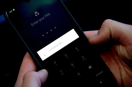 This photo illustration shows a man trying to log into his bank account through a mobile app in Sydney on 17 June 2021, as country's major banks reported online outages affecting their websites and apps. (Photo by Saeed KHAN / AFP)