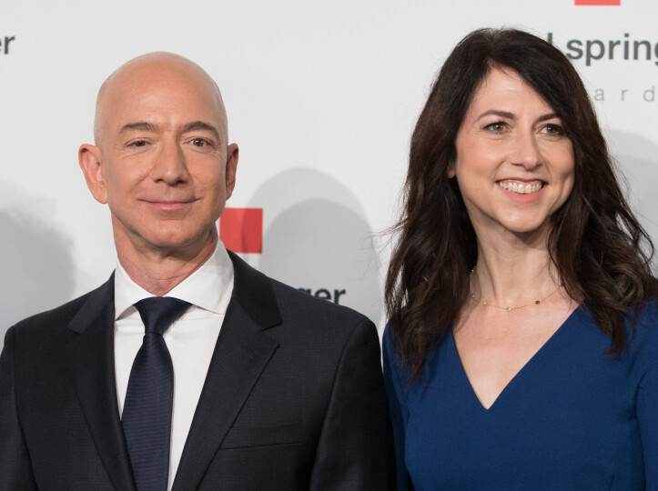 Amazon CEO Jeff Bezos and his wife MacKenzie Bezos poses as they arrive at the headquarters of publisher Axel-Springer where he will receive the Axel Springer Award 2018 on April 24, 2018 in Berlin. (Photo by JORG CARSTENSEN / dpa / AFP) / Germany OUT