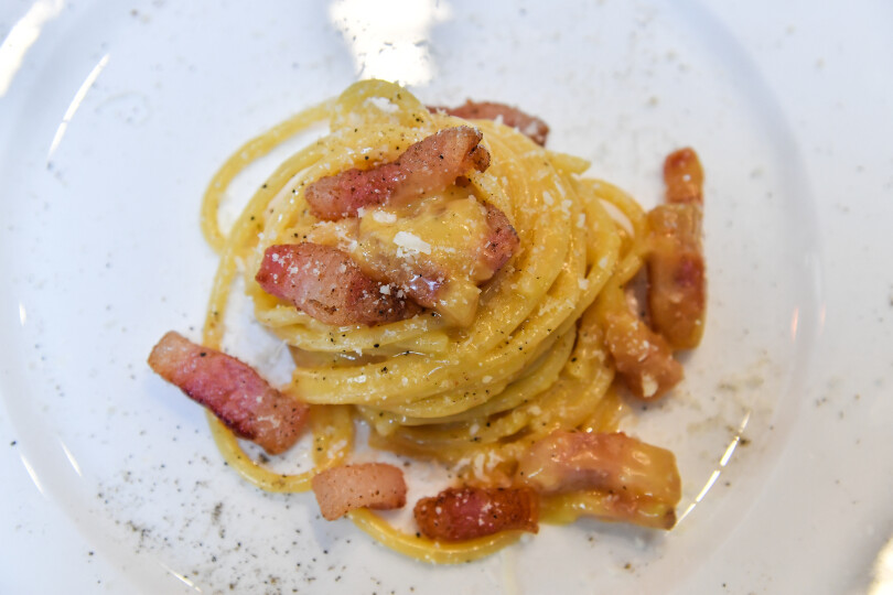 A view of the traditional famous Italian pasta dish "spaghetti alla carbonara", is taken during a preview for the press on April 5, 2019, one day before the international event Carbonara Day (#CarbonaraDay) in Rome. - The preview consists of three teams of cooking students challenge each other with modified Carbonara dishes, a traditional one, a vegan one and an experimental one. (Photo by Andreas SOLARO / AFP)