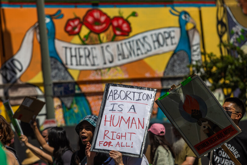 Protesters walk past a mural reading "there's always hope" during a demonstration in downtown Los Angeles on June 26, 2022, two days after the US Supreme Court released a decision on Dobbs v Jackson Women's Health Organization, striking down the right to abortion. - Elected leaders across the US political divide rallied on June 26 for a long fight ahead on abortion -- state by state and in Congress -- with total bans in force or expected soon in half of the vast country. (Photo by Apu GOMES / AFP)