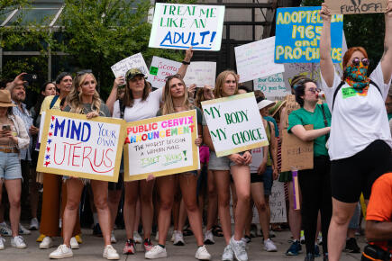 ATLANTA, GA - JUNE 25: Attendees hold signs during a protest against the Supreme Court's ruling in the Dobbs v Jackson Women's Health Organization on June 25, 2022 in Atlanta, Georgia. The Court's decision in the Dobbs v Jackson Women's Health case overturns the landmark 50-year-old Roe v Wade case, removing a federal right to an abortion. Elijah Nouvelage/Getty Images/AFP (Photo by Elijah Nouvelage / GETTY IMAGES NORTH AMERICA / Getty Images via AFP)