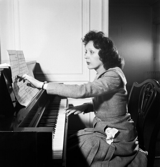 Image : Edith Piaf joue le titre "Un monsieur me suit dans la rue" chez elle à New York en Septembre 1946. Photo : Eric SCHWAB / AFP