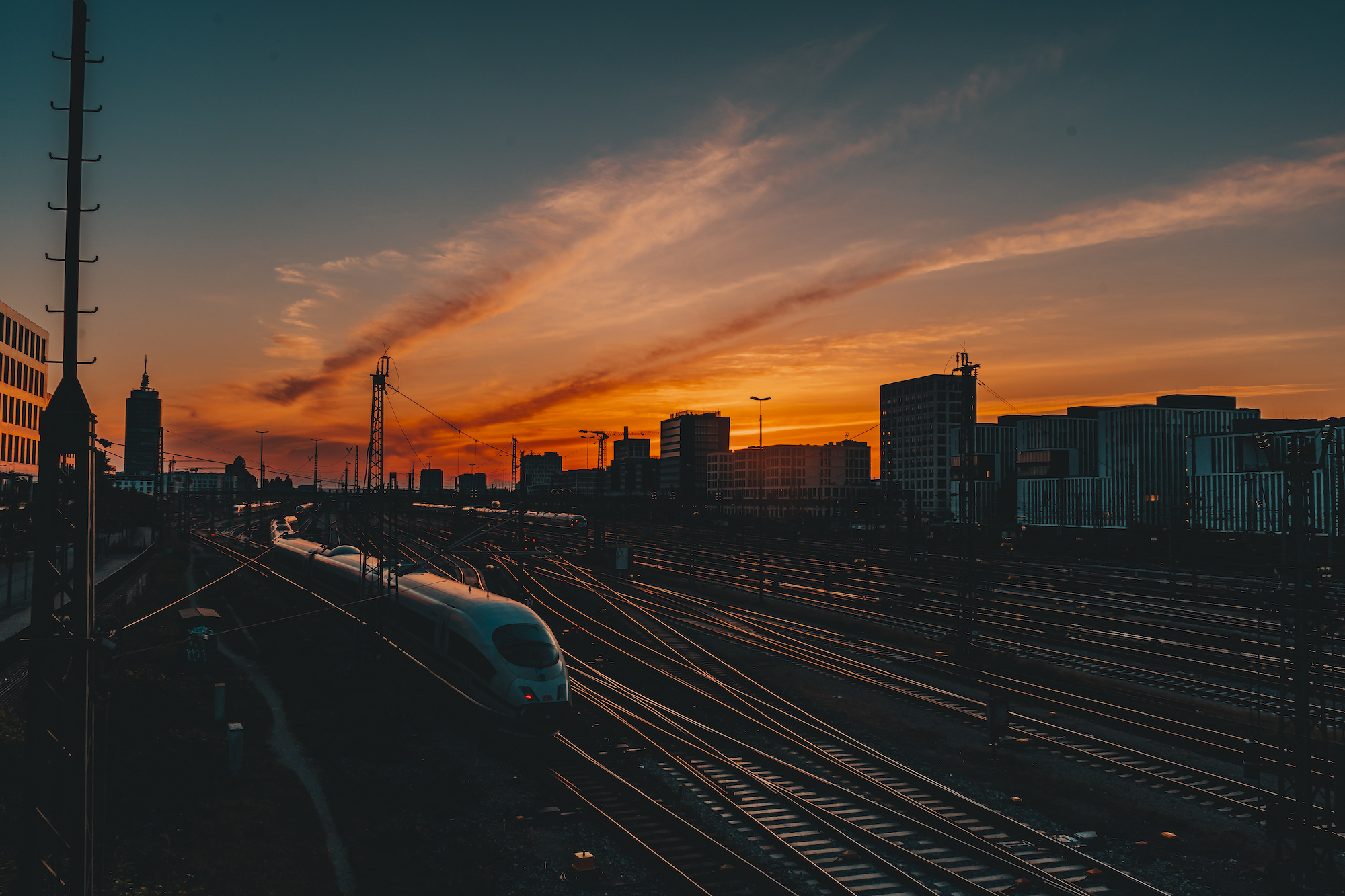 Panoramic-View-Of-Railroad-Tracks-By-Buildings-Against-Sky-During-Sunset_GettyimagesFrederik-Fernow-EyeEm
